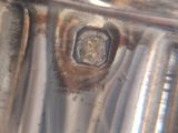 a close up of a silver plate on a table