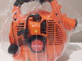 an orange blower sitting on top of a plastic bag on a table