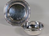 silver plate and bowl on a white surface with a gray background