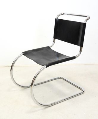 a black and chrome chair with a black leather seat