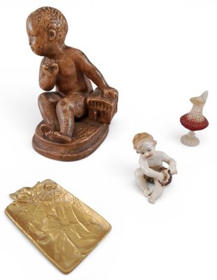 a small figurine of a boy sitting on a chair