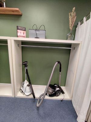 a vacuum that is sitting on the floor in the bathroom