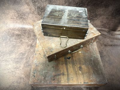 two old wooden boxes sitting on top of each other