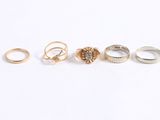 five different types of rings are shown on a white surface