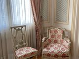 two chairs in the corner of a room near a window