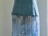 a dress on a mannequin stand in front of a window