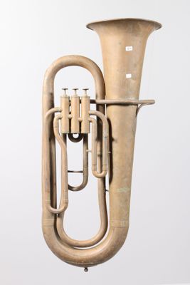a brass instrument that is sitting on a stand