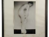 a black and white photo of a naked man standing in front of a wall