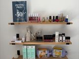 a shelf that has various cosmetics and cosmetics products on it
