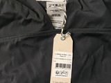 the back of a black jacket with a tag on it