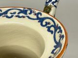 a close up of a cup with a handle on a table