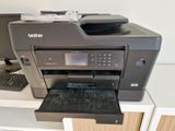 a printer that is sitting on a desk next to a keyboard
