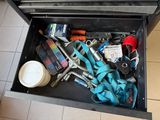 a tool box with tools in it on a tiled floor
