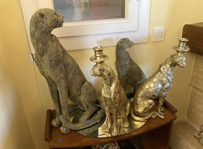 a small table with a bunch of silver figurines on top of it