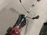 a picture of a string trimmer and a corded edger in a garage