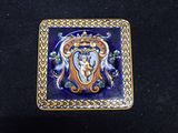 a picture of a blue and gold tile with a picture of a woman on it