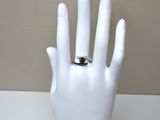 a white mannequin hand with a ring on it