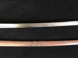 two swords are displayed on a black surface with a gold handle