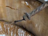 a close up of a metal object with a rope on it