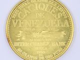 a gold coin with a picture of a boat on it