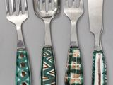 four pieces of silverware with green and brown designs on them