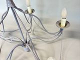 a chandelier with five lights attached to it on a table