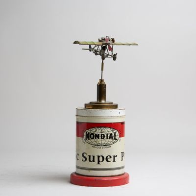 an old tin can with a small airplane on top of it