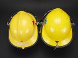 pair of yellow hard hats sitting on top of a black surface