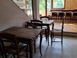 a room with a lot of tables and chairs in it