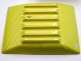 a close up of a yellow plastic object on a white surface