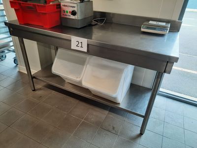 a table with two bins on it in a kitchen