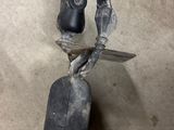 a metal object with a knife on it on the floor