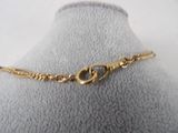 a close up of a gold bracelet on a mannequin mannequin