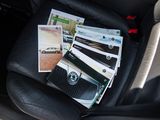 a bunch of papers sitting on the back seat of a car