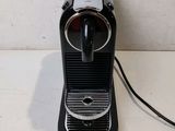 a small black coffee machine on a counter