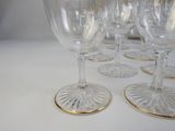 several empty wine glasses are lined up on a table