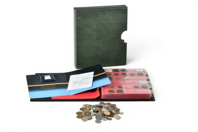 a green book with a red cover and a pile of coins