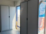 a refrigerator in a room with a lot of cupboards