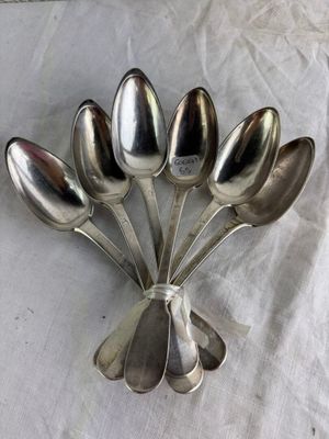 five spoons arranged in the shape of a flower on a table