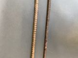 pair of wooden walking canes with a wooden handle on a metal surface