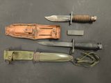 several different types of knives and sheaths laid out on a table