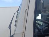 a white truck with a green leaf on the side of it