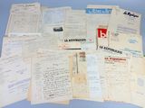 many papers are piled on top of each other on a table