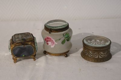 three small vases that are sitting on a table