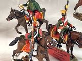many figurines of soldiers riding horses on display