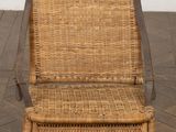 a wicker chair that is sitting on a wooden floor
