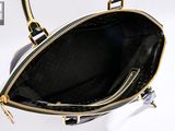 the inside of a black and gold purse with a gold zipper