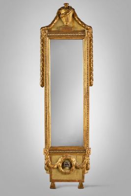 a gold mirror with a lion head on the top of it