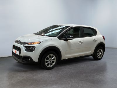 the white car is parked in a large room with white walls
