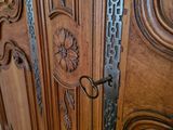 a large wooden cabinet with a pair of scissors on it